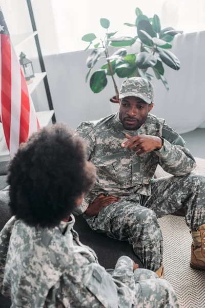 Пара солдат или солдат разговаривают дома на диване — стоковое фото