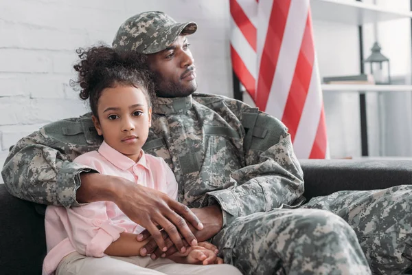 Father in army uniform hugging african american daughter — Stock Photo