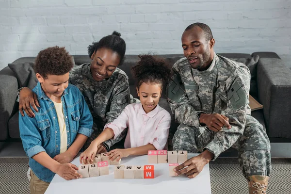 Army soldiers with happy kids playing words game — Stock Photo