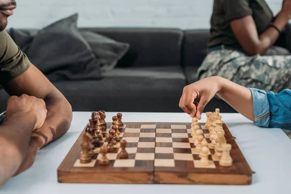 African american father playing chess with his son — Stock Photo