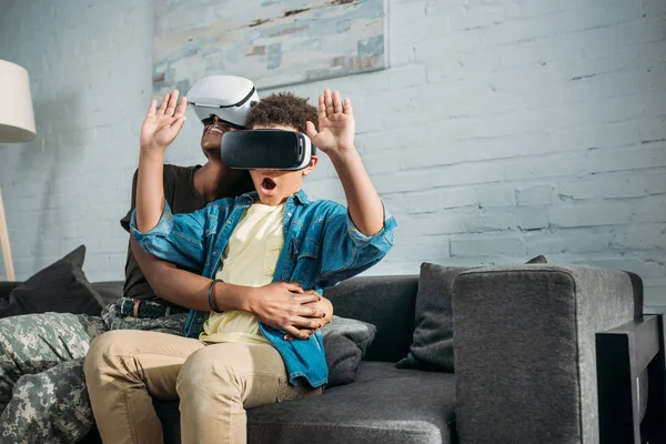 Mother soldier and african american boy using virtual reality headsets — Stock Photo
