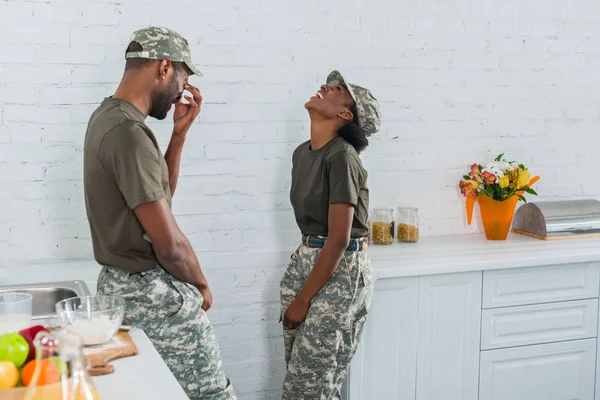 Couple of african american soldiers laughing together in kitchen — Stock Photo