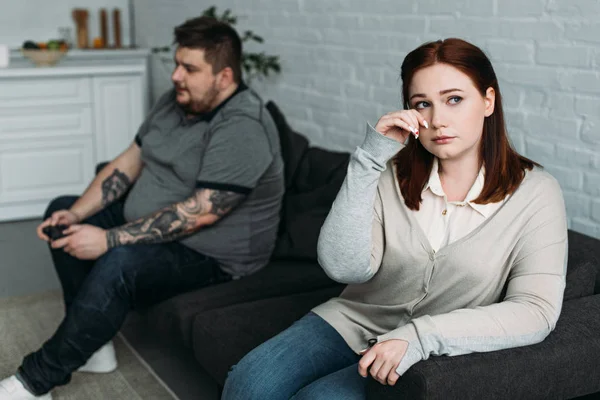 Girlfriend crying and boyfriend playing video game at home — Stock Photo