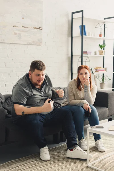 Boyfriend winning video game at girlfriend at home — Stock Photo