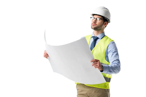 Confident architect in glasses wearing reflective vest and hardhat looking at blueprint isolated on white — Stock Photo