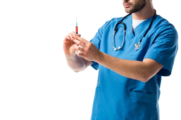 Close-up view of syringe in hands of male nurse wearing blue uniform with stethoscope isolated on white — Stock Photo