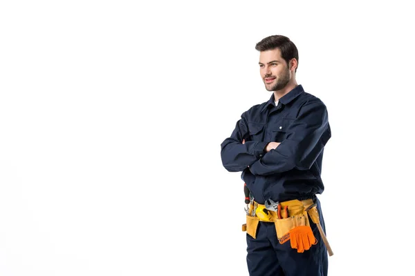 Vista laterale dell'idraulico in uniforme con braccia incrociate isolate su bianco — Foto stock