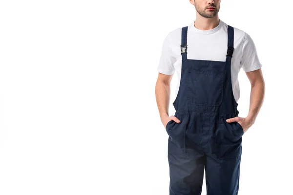 Vista parziale di detergente in uniforme con le mani in tasche isolate su bianco — Foto stock