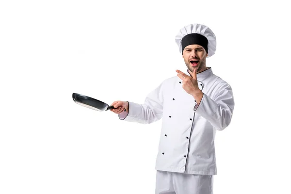 Portrait of emotional young chef in uniform with frying pan isolated on white — Stock Photo