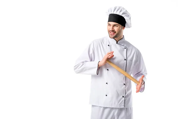 Smiling chef in uniform with wooden rolling pin isolated on white — Stock Photo