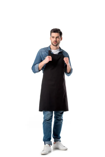 Young bearded waiter in apron looking away isolated on white — Stock Photo