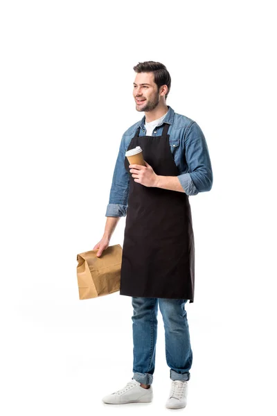 Smiling waiter in apron with order to go in hands isolated on white — Stock Photo