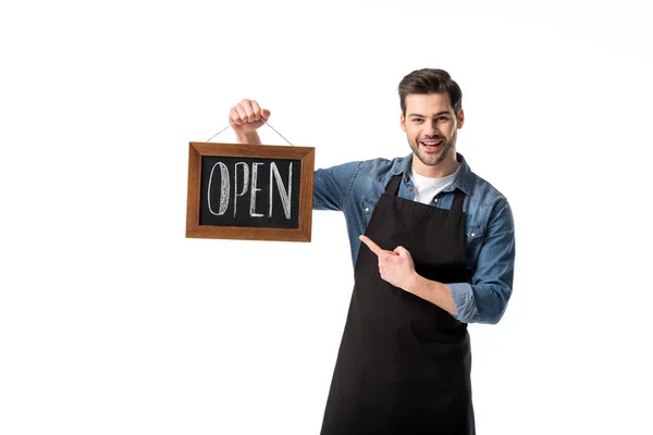 Portrait of smiling waiter pointing at open blackboard in hand isolated on white — Stock Photo