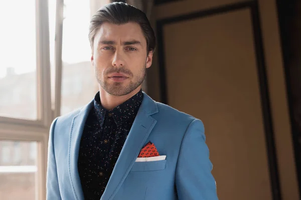 Close-up portrait of handsome young man in stylish blue jacket — Stock Photo