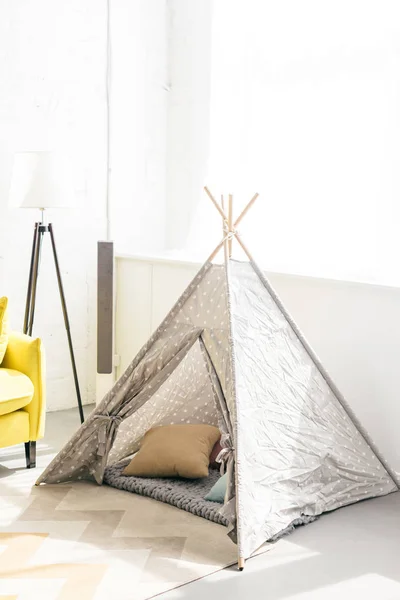 Vue rapprochée du tipi enfantin avec oreillers dans la chambre — Photo de stock