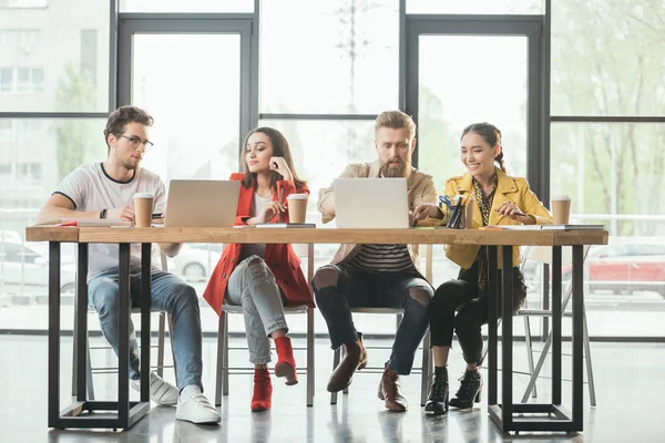 Diverse business team working on project in light workspace — Stock Photo