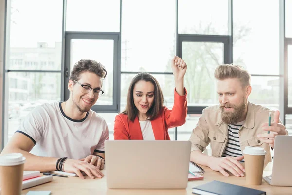 Diverse business team working on project and celebrating success in light workspace — Stock Photo