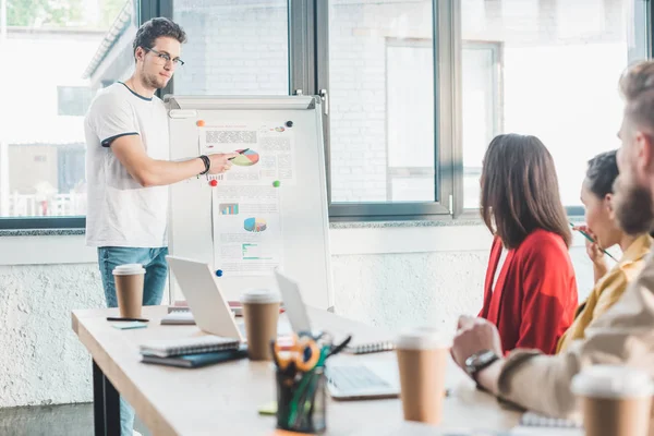 Diverse business team listening to presentstion in light workspace — Stock Photo