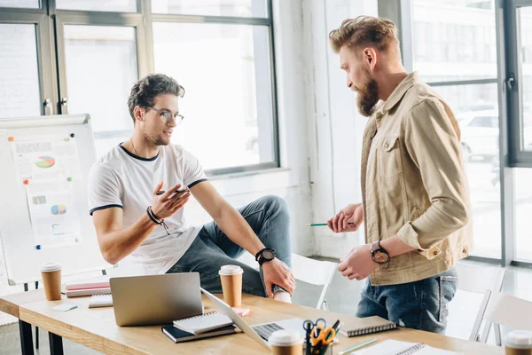 Successful managers discussing business results in modern light office — Stock Photo