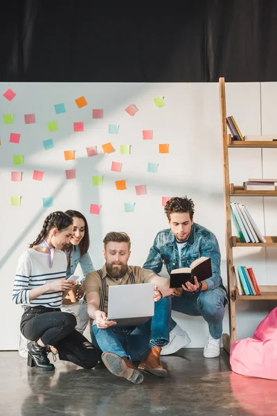 Diverse business team making research on project in light workspace — Stock Photo