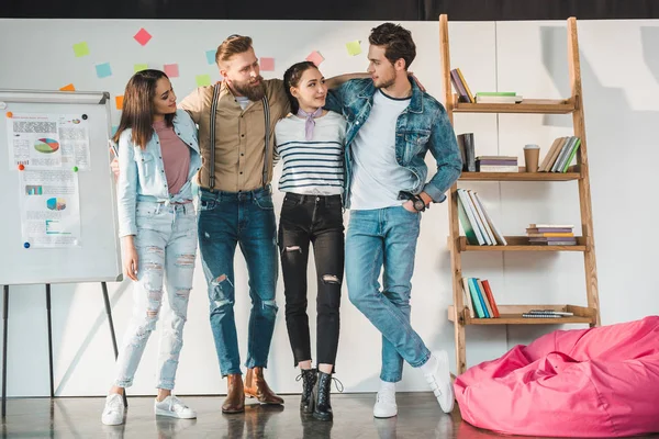 Successful business people embracing in modern light office — Stock Photo