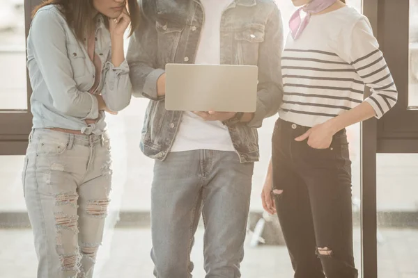 Ausgeschnittene Ansicht eines Geschäftsteams, das an einem Laptop in einem hellen Arbeitsbereich arbeitet — Stockfoto