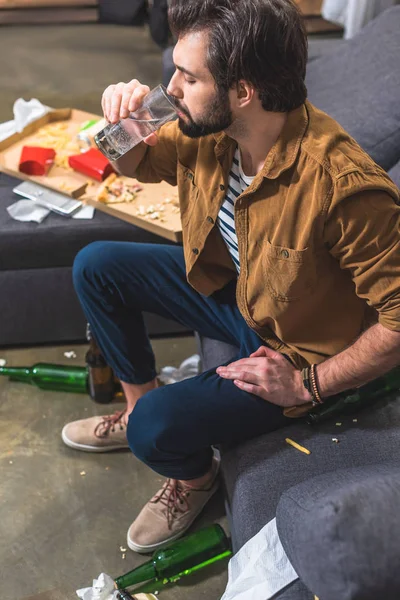 High angle view of loner drinking water and having hangover at living room — Stock Photo