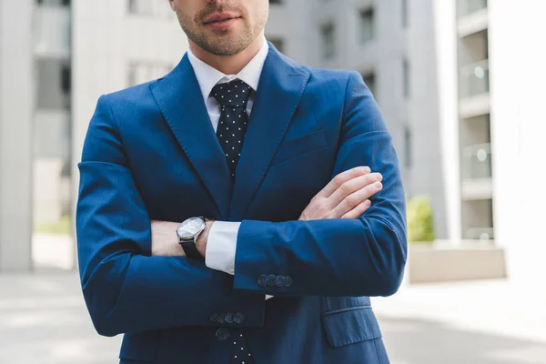 Cropped shot of businessman in stylish suit with crossed arms — Stock Photo