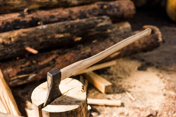 Close up view of sticking axe in log at sawmill — Stock Photo