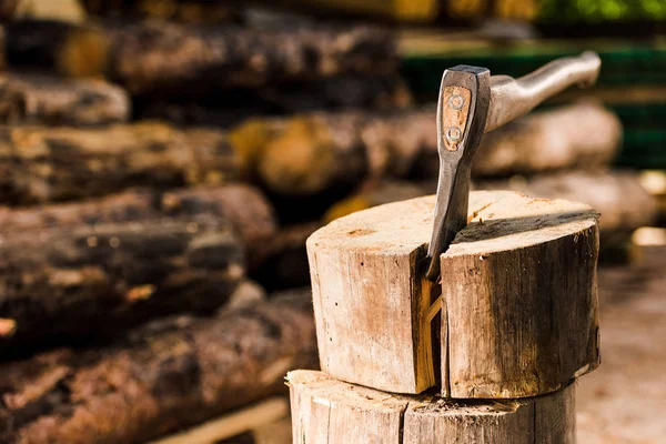 Closeup view of sticking axe in log at sawmill — Stock Photo