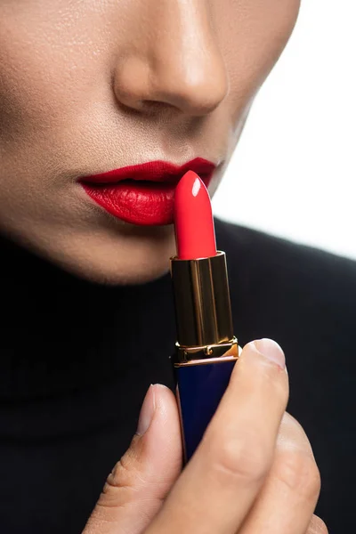Cropped view of beautiful woman with red lips applying lipstick isolated on white — Stock Photo