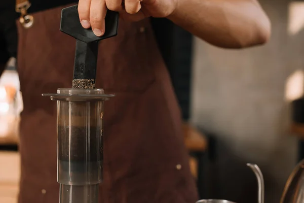 Cropped view of barista preparing coffee with aeropress — Stock Photo