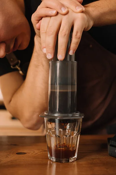 Partial view of barista preparing coffee with aeropress — Stock Photo