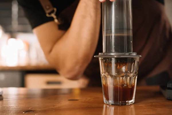 Partial view of barista preparing coffee with aeropress — Stock Photo