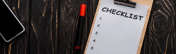 Panoramic shot of smartphone with blank screen near checklist on table, e-commerce concept — Stock Photo