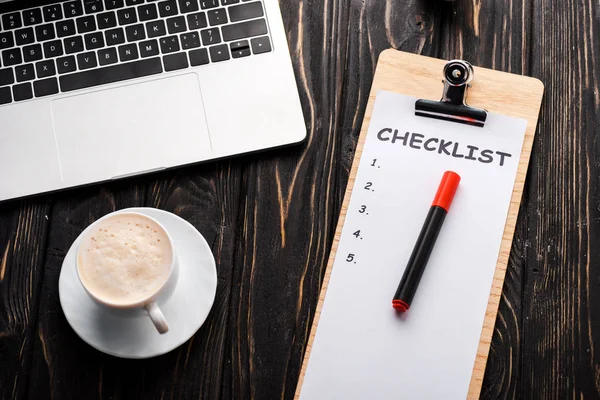 Top view of laptop near checklist, red marker pen and cup of coffee on table, e-commerce concept — Stock Photo