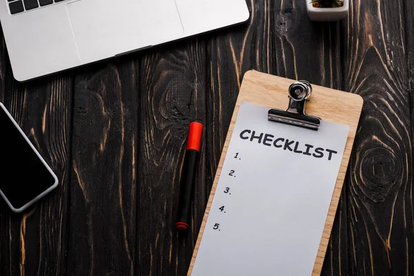 Top view of gadgets near checklist and red marker pen on table, e-commerce concept — Stock Photo