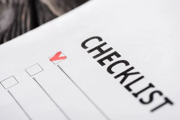 Close up of checklist with red tick — Stock Photo