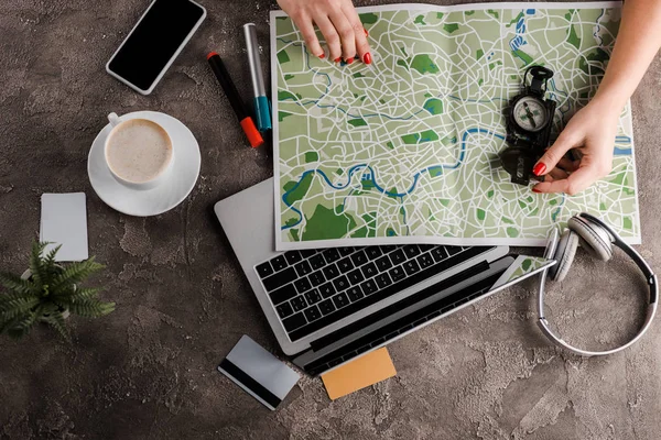 Top view of woman near map, compass, credit cards and gadgets, e-commerce concept, e-commerce concept — Stock Photo