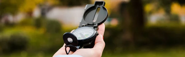 Panoramic shot of woman holding retro compass — Stock Photo