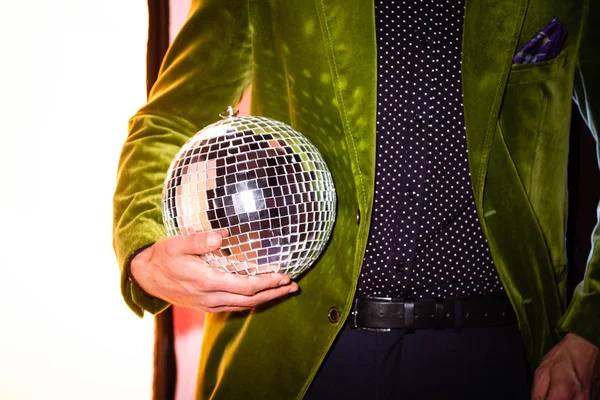 Cropped view of man holding shiny disco ball on white — Stock Photo
