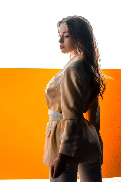 Jeune belle femme en blazer avec ceinture sur orange et blanc — Photo de stock