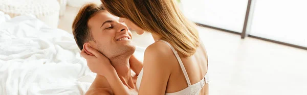 Plano panorámico de novia abrazando y besando novio en apartamento - foto de stock
