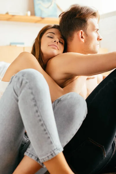 Girlfriend with closed eyes hugging handsome boyfriend in apartment — Stock Photo