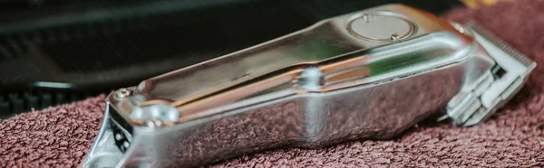 Panoramic shot of trimmer on towel in barbershop — Stock Photo