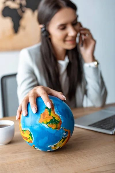 Selective focus of travel agent holding hand on globe — Stock Photo