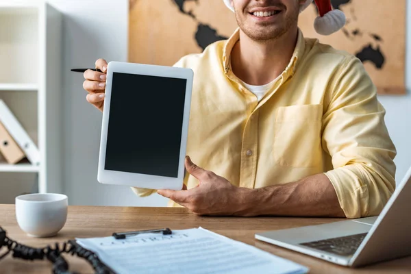 Vista recortada de agente de viajes sonriente sosteniendo tableta digital con pantalla en blanco - foto de stock