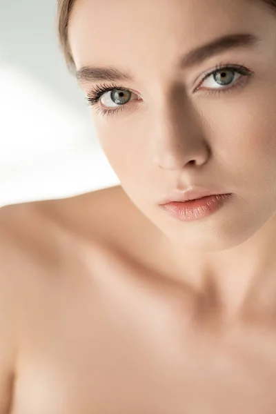 Beautiful naked girl looking at camera on white — Stock Photo