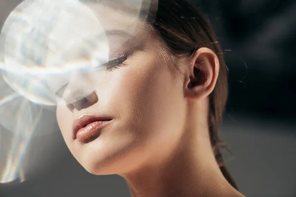 Portrait of attractive elegant girl on grey with lens flares — Stock Photo