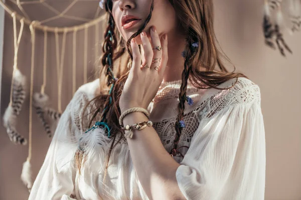 Cropped view of girl with braids in white boho dress on beige with dream catcher — Stock Photo